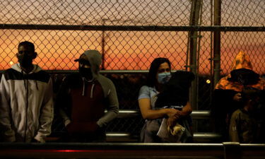 Migrants in the "Remain in Mexico" program queue at the Paso del Norte border bridge to reschedule their immigration hearings in Ciudad Juarez