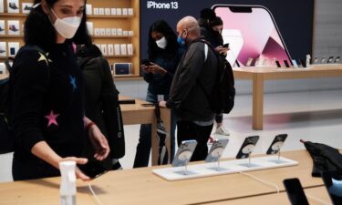 People shop at the Fifth Avenue Apple Store during the launch of Apple's new iPhone 13 and iPhone 13 Mini on September 24 in New York City.