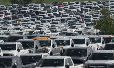 New Ford F-Series pickup trucks are stored in a lot during a semiconductor shortage at Kentucky Speedway in Sparta