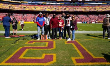 Members of the late Sean Taylor's family gather on the field as the Washington Football Team retire his number during a ceremony before the start of an NFL football game against the Kansas City Chiefs