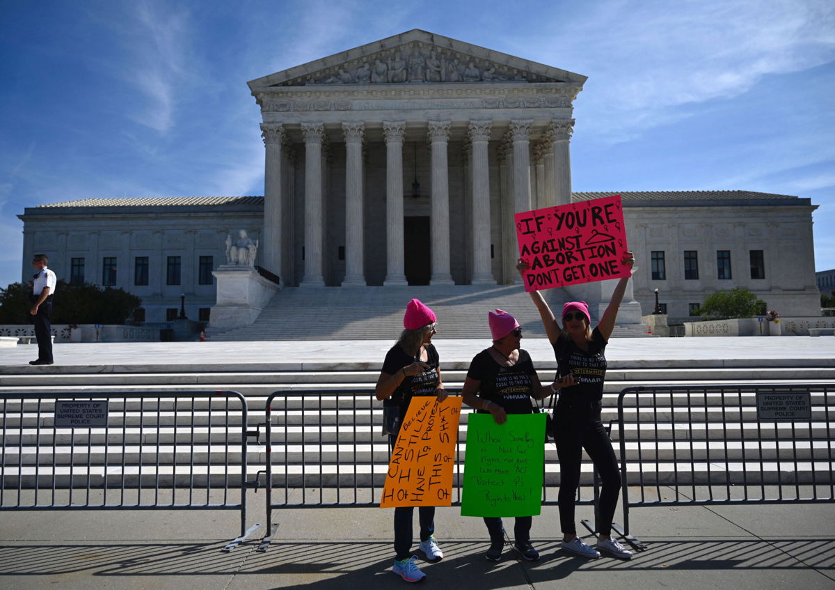 <i>Andrew Caballero-Reynolds/AFP/Getty Images</i><br/>Protesters hold signs in front of the Supreme Court during the Women's March and Rally for Abortion Justice in Washington