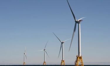 Wind turbines tower over the water off the shores of Block Island