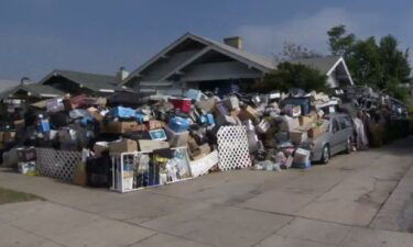 The 8-foot wall of junk contains items like old doors