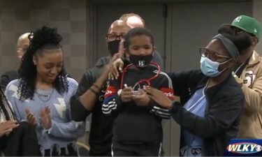 5-year-old son Malakai Roberts (center) receives a red stethoscope on November 7 while signing up for the Future Healers Program in Louisville KY. Malakai was hit in the head with a stray bullet in December 2020 and blinded.