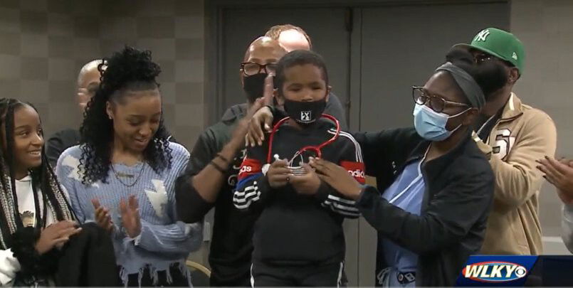 <i>WLKY</i><br/>5-year-old son Malakai Roberts (center) receives a red stethoscope on November 7 while signing up for the Future Healers Program in Louisville KY. Malakai was hit in the head with a stray bullet in December 2020 and blinded.