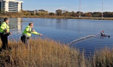 Massachusetts State Police troopers pull in a man who fell into the Neponset River in Dorchester on November 6 while trying to retrieve a drone.