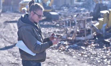 Co-owner Sarah Vassh of Vassh Excavating & Grading Inc. on Tuesday afternoon examines a POW/MIA bracelet her employee Sam DuVall found among the rubble of 1500 N. Memorial Drive. The name on the bracelet is James K. Patterson and Vassh Excavating is hoping to connect the bracelet with its owner.