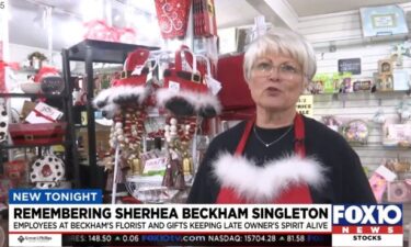 Avis Beasley stands in front of a display at Beckham's Florist and Gifts in Mobile