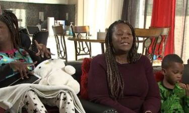 Lillian Proctor (center) sits next to her 28-year-old daughter