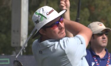 Joel Dahmen wears a  MD Anderson Cancer Center strike-out cancer hat at the Houston Open. Dahmen is a testicular cancer survivor