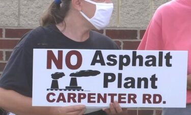 Residents of mid-Michigan continued to protest the construction of a proposed asphalt plant by holding a vigil for the death of clean air in their community.