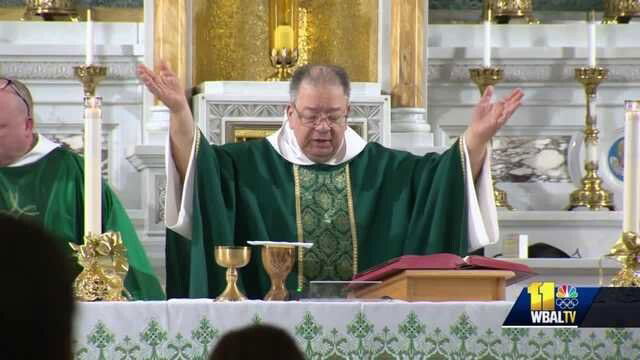 <i>WBAL</i><br/>Father Bernard Carman worships during Mass. Father Carman was injured during an armed robbery in Baltimore.