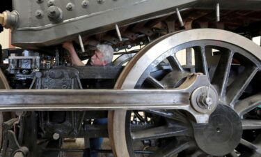 Steve Roudebush works on the underside of a 1907 steam locomotive at SPEC Machine north of Middleton on Thursday.