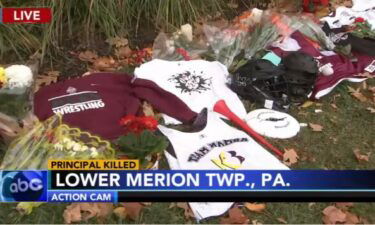 A memorial sits outside the office window of Sean Hughes