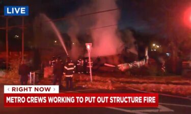 Firefighters in Nashville put water on the smoldering ruins of a home on November 29. The home collapsed as a result of a fire.