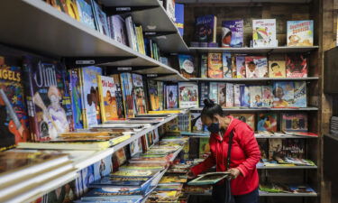 A patron browses in the children's book section at Frugal Bookstore in Boston on Nov. 28