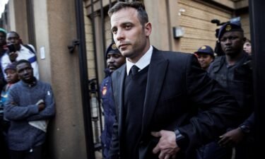 South African Paralympian Oscar Pistorius leaves the Pretoria High Court on June 15