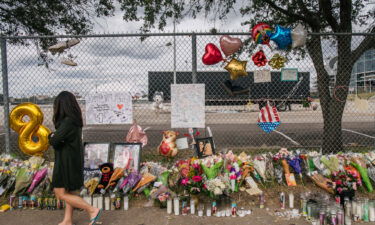 A woman walks past a memorial to those who died at the Astroworld festival outside of NRG Park on November 09