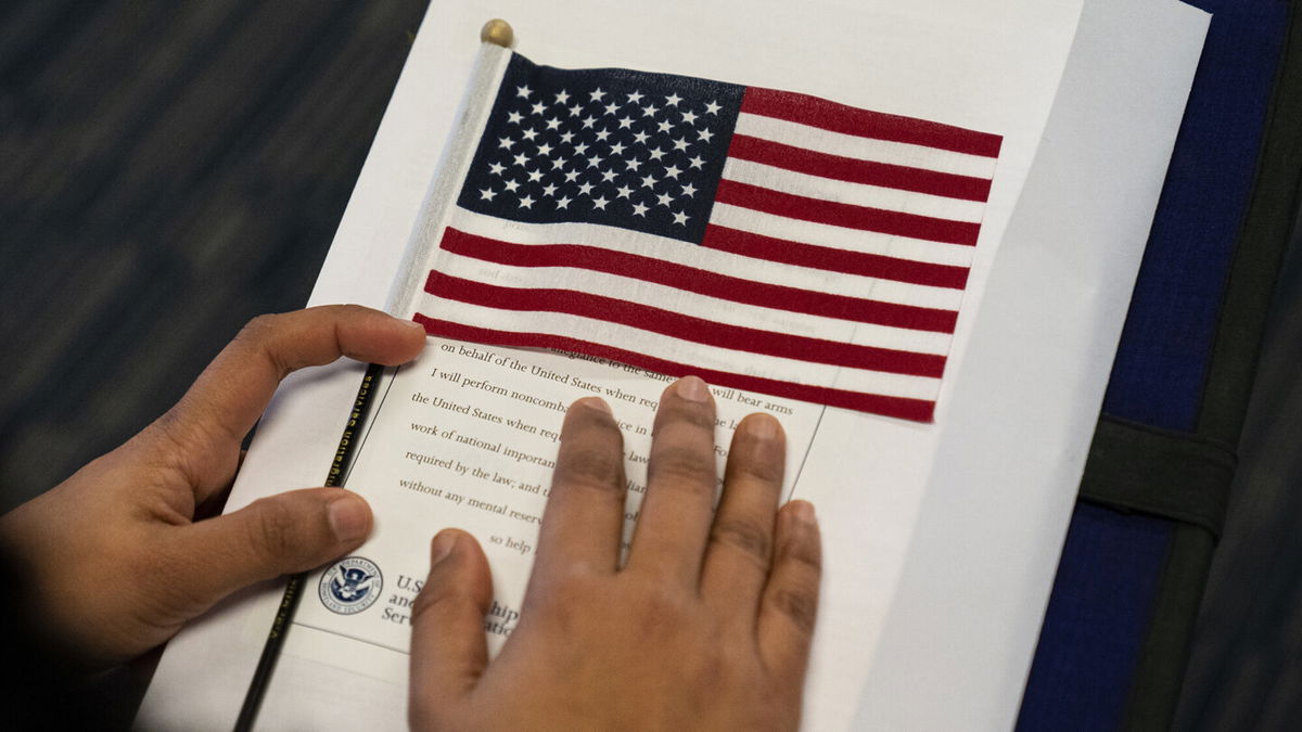 <i>Robert Nickelsberg/Getty Images</i><br/>Months-long processing delays leave people out of work amid nationwide labor shortage. This image is from a naturalization ceremony