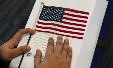 Months-long processing delays leave people out of work amid nationwide labor shortage. This image is from a naturalization ceremony