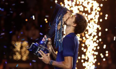 Alexander Zverev celebrates with the ATP Finals trophy.