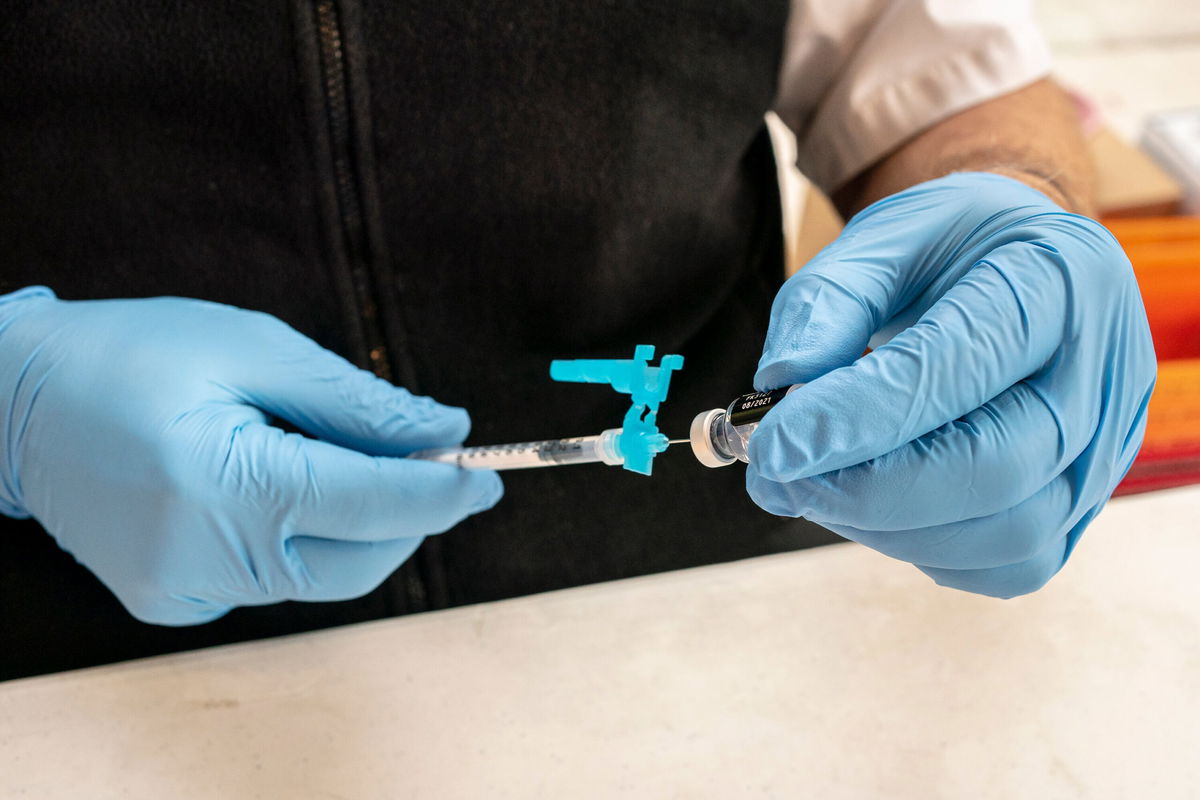 <i>David Ryder/Getty Images</i><br/>A firefighter prepares pediatric doses of the Pfizer-BioNtech Covid-19 vaccine on November 3 in Shoreline