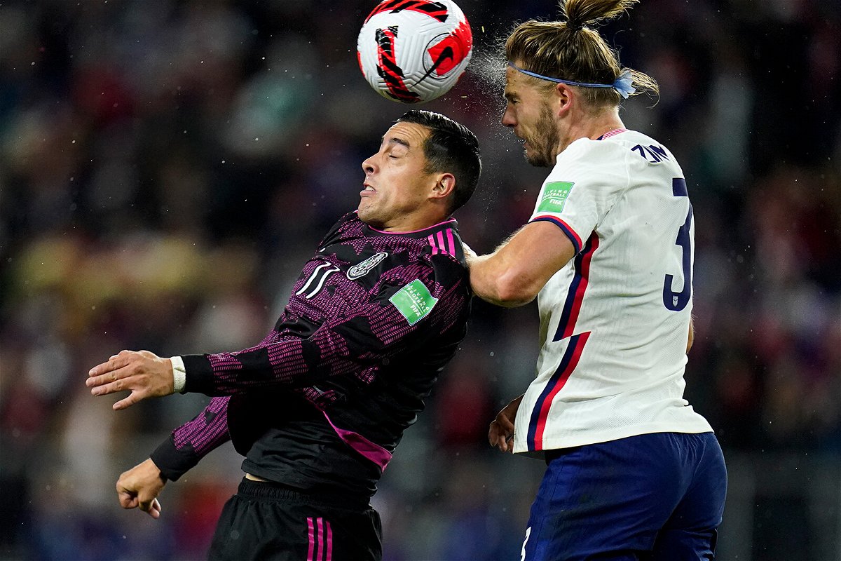 <i>Julio Cortez/AP</i><br/>Mexico's Rogelio Funes Mori challenges for the ball against Walker Zimmerman.