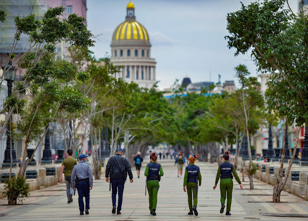 <i>YAMIL LAGE/AFP/AFP via Getty Images</i><br/>The city of Havana saw a heavy police presence on Monday morning as authorities prepared to face potential protesters. Police officers are shown along El Paseo del Prado street in Havana