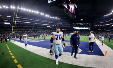 The Dallas Cowboys' Zack Martin and Micah Parsons walk off the field after losing against the Las Vegas Raiders.
