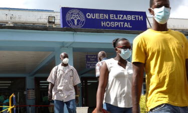 People walk from the entrance to the Queen Elizabeth hospital in Bridgetown
