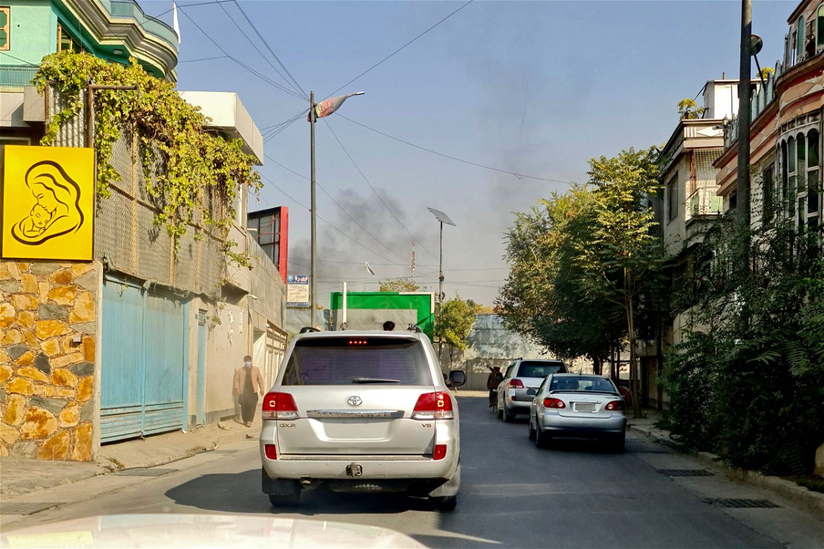 <i>AFP/Getty Images</i><br/>Vehicles move along a road against the backdrop of smoke rising from the site of blast in Kabul on November 2 after at least 16 people were wounded in two blasts at a military hospital.