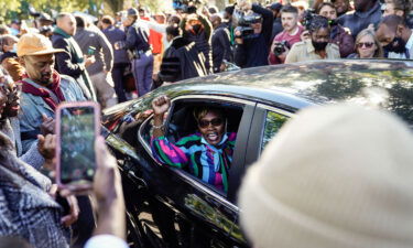 Ahmaud Arbery's mother Wanda Cooper-Jones gestures to supporters as she leaves the Glynn County Courthouse in Brunswick