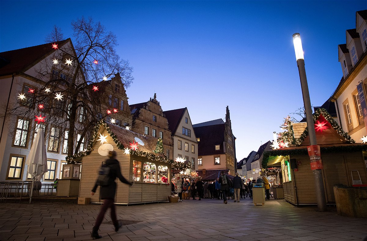 <i>Friso Gentsch/picture alliance/Getty Images</i><br/>Skyrocketing infections in Germany have sparked questions about whether the region's largest economy could reimpose sweeping restrictions. A Christmas market is shown here on November 22