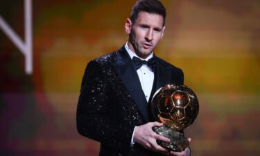 Lionel Messi poses after being awarded the Ballon d'Or.