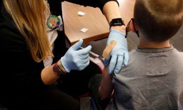Kids receiving their first dose of the Covid-19 vaccine now will be partially protected by Thanksgiving. An 8-year-old receives the Pfizer-BioNTech vaccine in Southfield