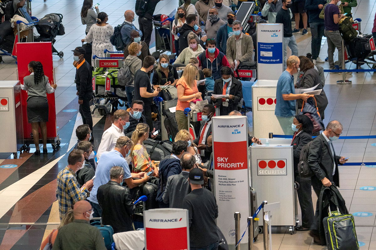 <i>Jerome Delay/AP</i><br/>People line up to get on the Air France flight to Paris at OR Tambo International Airport in Johannesburg