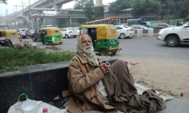 Gulpreet Singh begs for food outside Delhi's South Campus station. He struggles to breathe in the pollution.