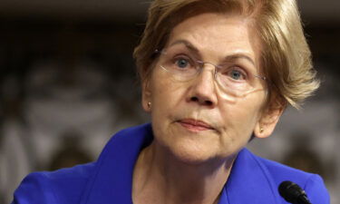 Democratic Senator Elizabeth Warren wants federal regulators to investigate whether any laws were broken by the shell company that is facilitating former President Donald Trump's return to Wall Street. Warren is shown here on September 28