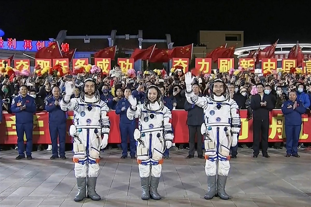 <i>CCTV/AFP/Getty Images</i><br/>The three-member Shenzhou-13 crew at a departure ceremony on October 15 before their launch