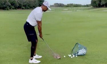 Golfing legend Tiger Woods posted a short video of himself taking a practice shot out on a golf course on Sunday.