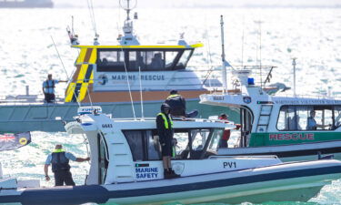 Search and Rescue vessels are seen patrolling off Port Beach in North Fremantle