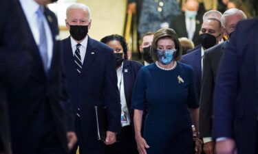 U.S. President Joe Biden is escorted by House Speaker Nancy Pelosi (D-CA) as he arrives to speak with the House Democratic Caucus to provide an update on the Build Back Better agenda and the bipartisan infrastructure deal at the U.S. Capitol in Washington