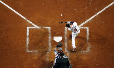 Freddie Freeman of the Braves hits a solo homer in the third inning during Game 5.
