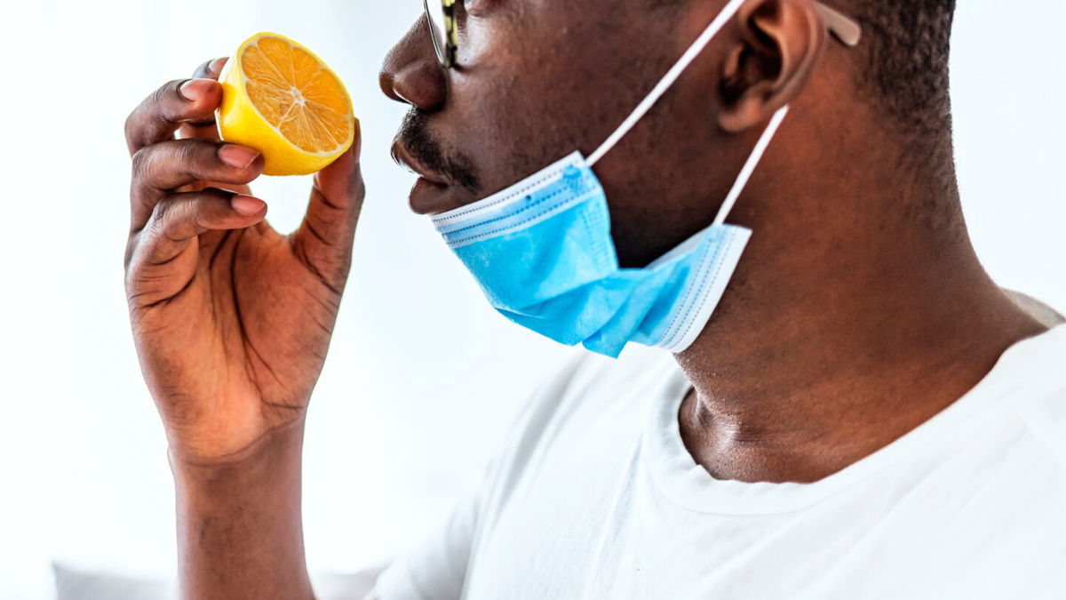 <i>ljubaphoto/E+/Getty Images</i><br/>A man tries to smell a lemon