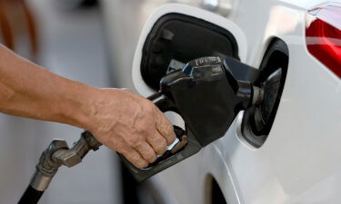 A customer pumps gas into his vehicle at a Shell station on November 22