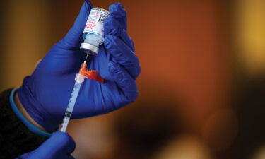 A medical technician fills a syringe from a vial of the Moderna COVID-19 vaccine in Bates Memorial Baptist Church February 12 in Louisville