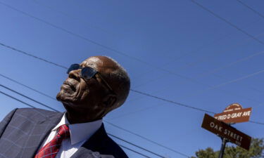 Fred Gray poses with the street renamed in his honor at the Fred D. Gray Avenue dedication ceremony in October. The capital of Alabama is coming under fire and facing a large fine after removing a street name honoring president of the Confederacy.