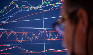 The market may be ignoring risks and signs of froth and excess. A trader is shown working on the floor of the New York Stock Exchange (NYSE) in New York