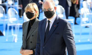Prince Albert II (right) and Princess Charlene leave a ceremony in Nice