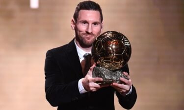Messi poses with his sixth Ballon d'Or trophy in 2019.